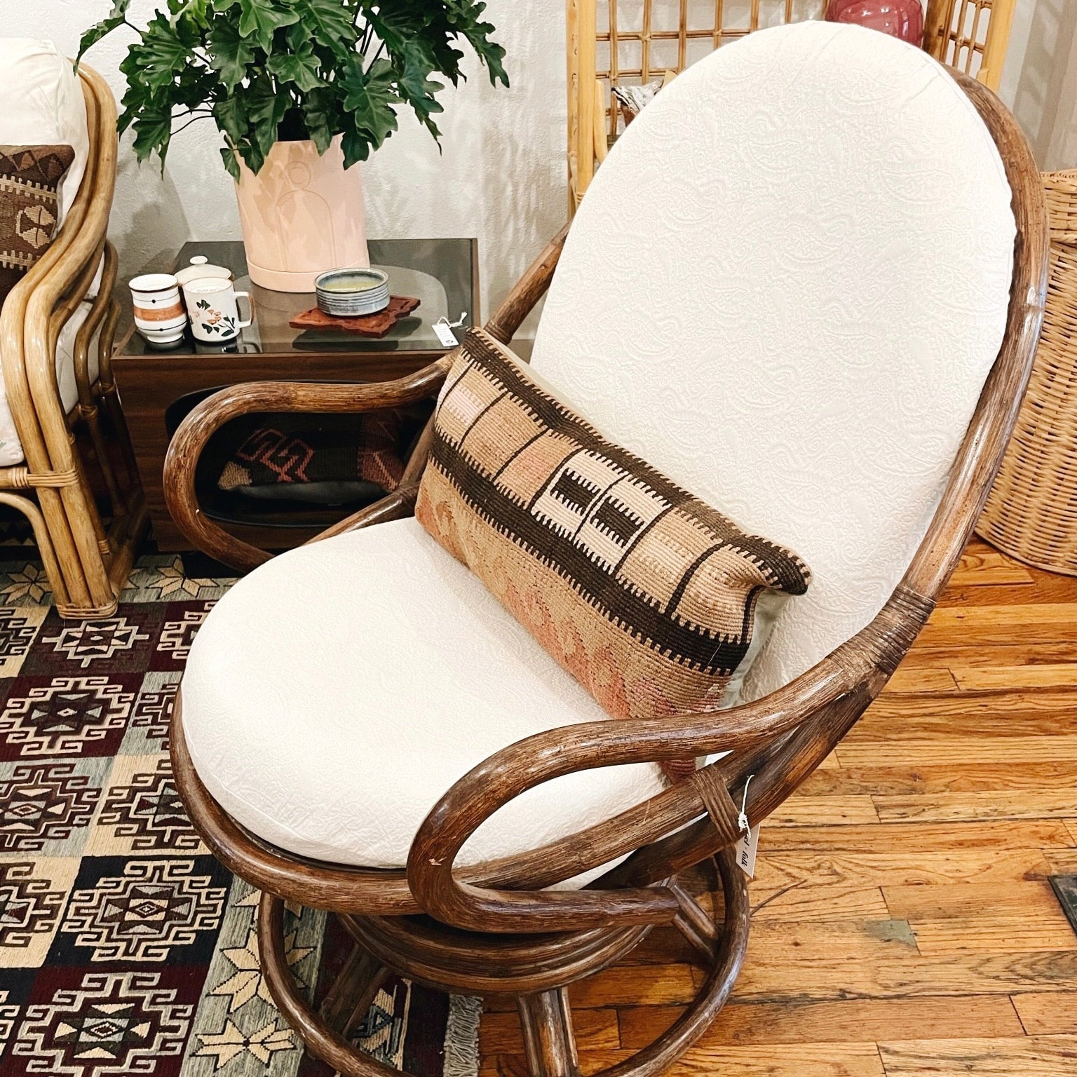 Vintage rattan swivel chair with white textured cushion carousel